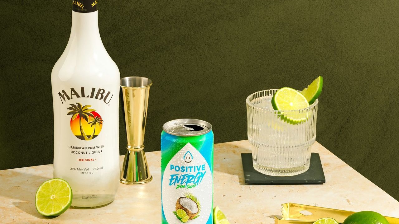 a table topped with bottles of alcohol and limes