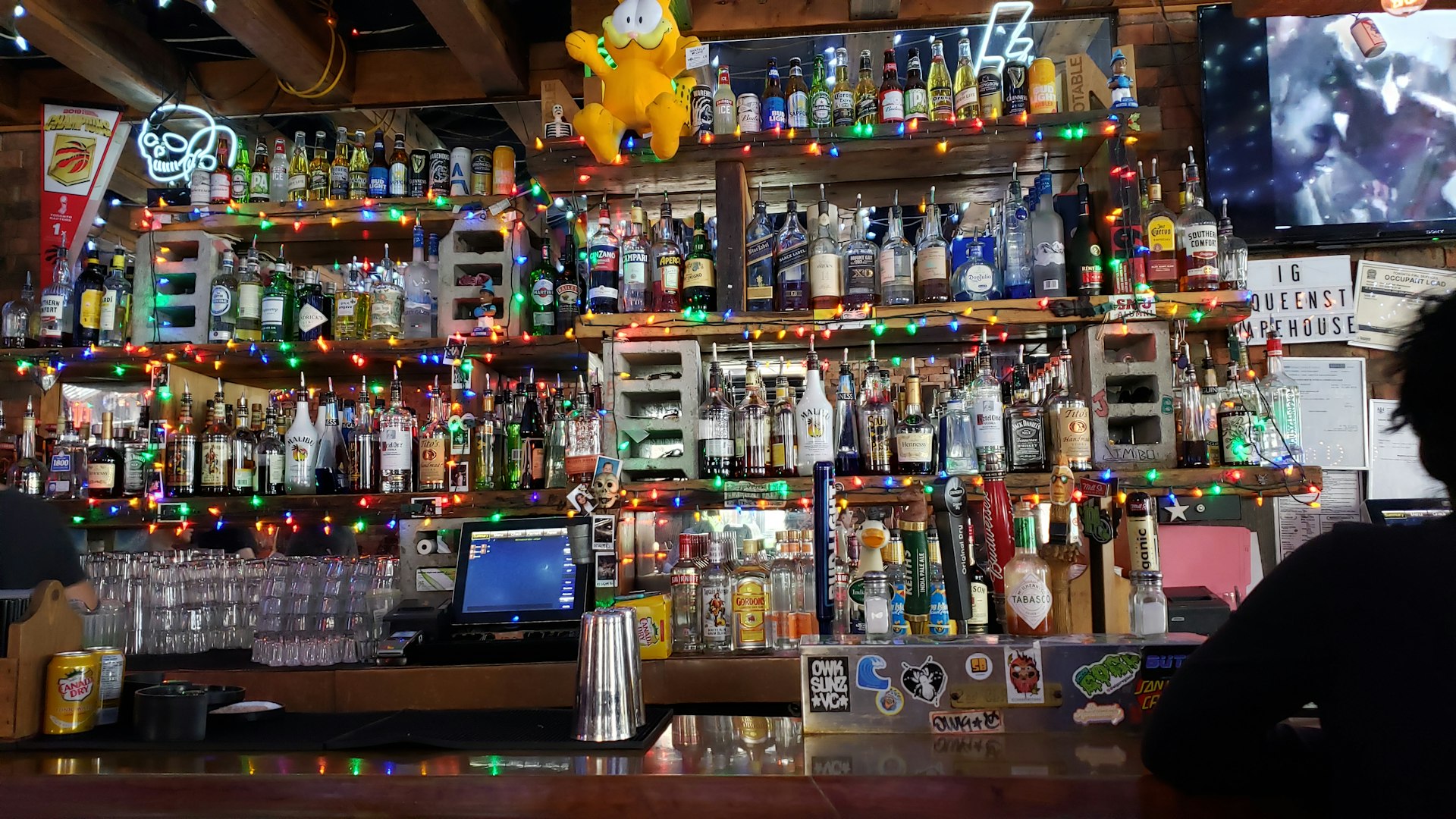 a man sitting at a bar in front of a television