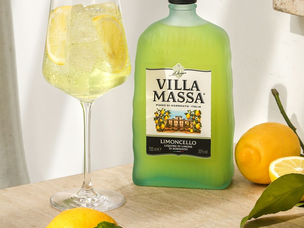 a bottle of alcohol next to a glass of wine