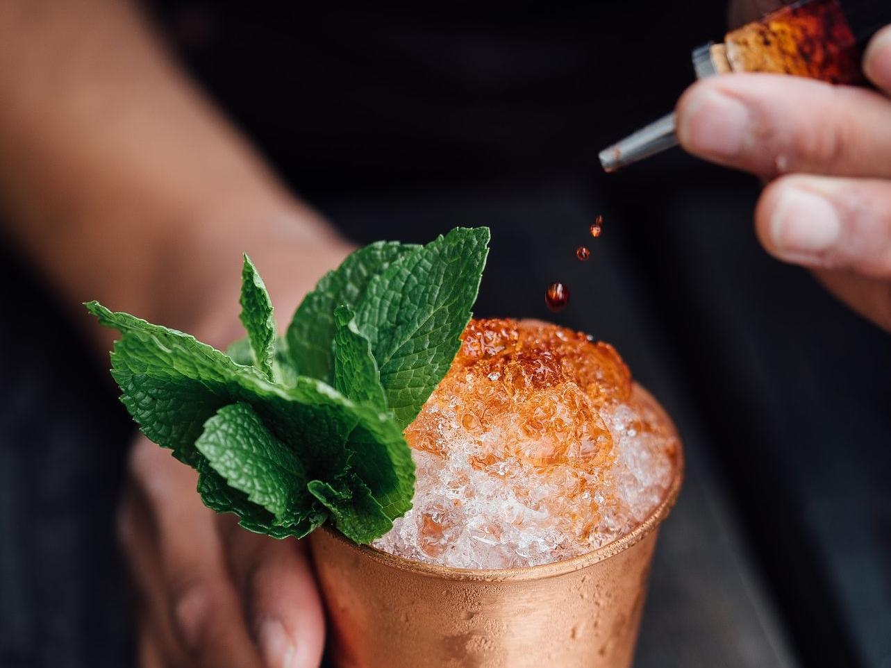 brass-colored cup filled with crushed ice with mint