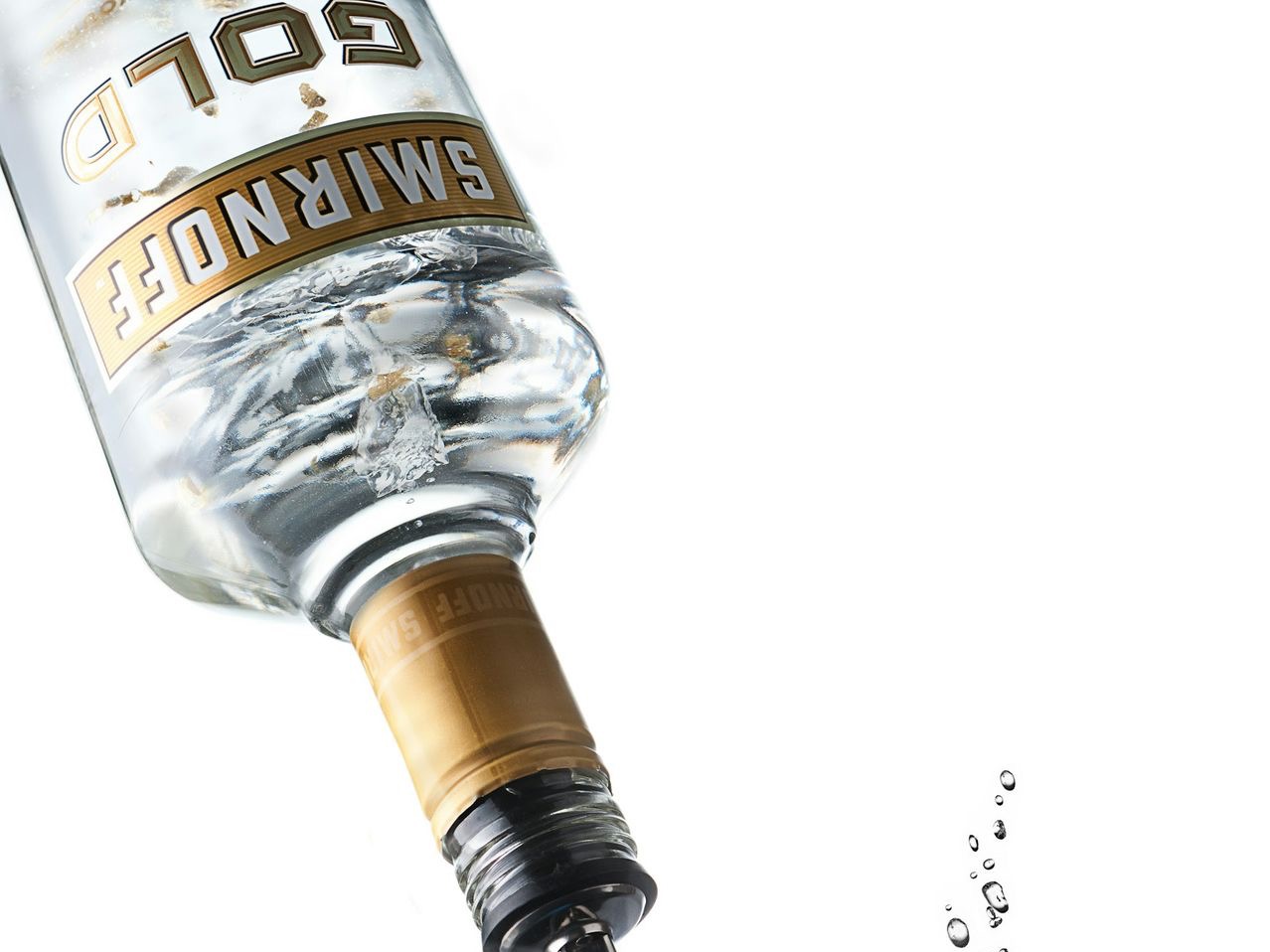 clear glass bottle with brown liquid